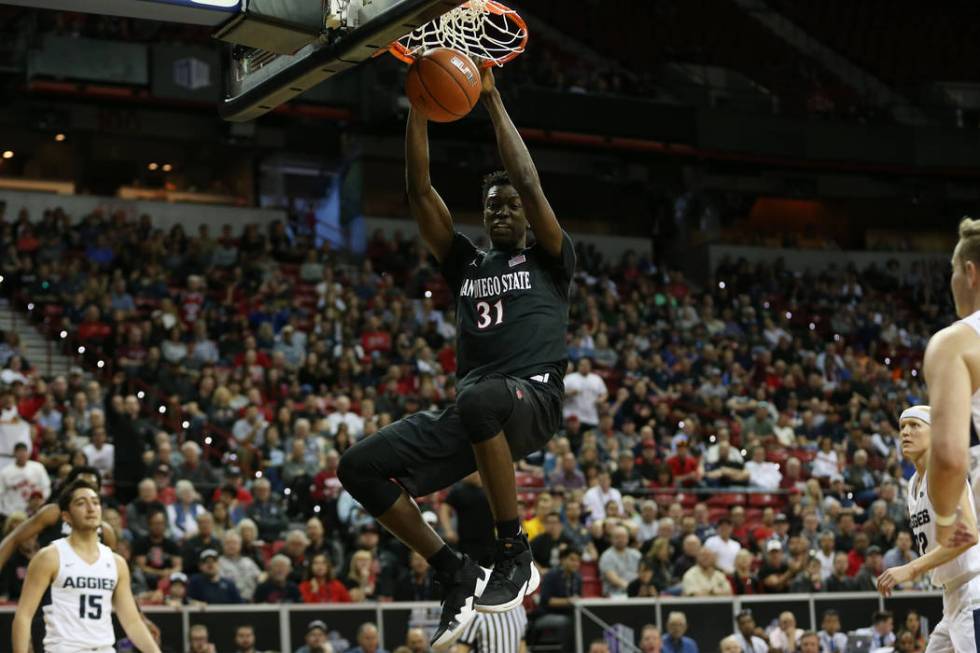 San Diego State Aztecs forward Nathan Mensah (31) dunks the ball against Utah State Aggies in the first half of the Mountain West tournament men's basketball championship game at the Thomas & ...