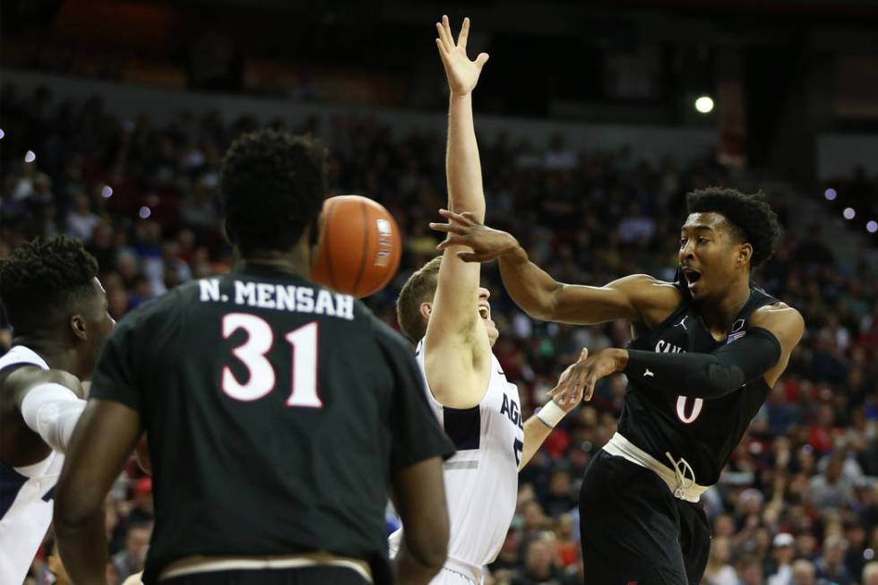 San Diego State Aztecs forward Jalen McDaniels (5) makes a pass under pressure from Utah State Aggies guard Sam Merrill (5) in the first half of the Mountain West tournament men's basketball champ ...