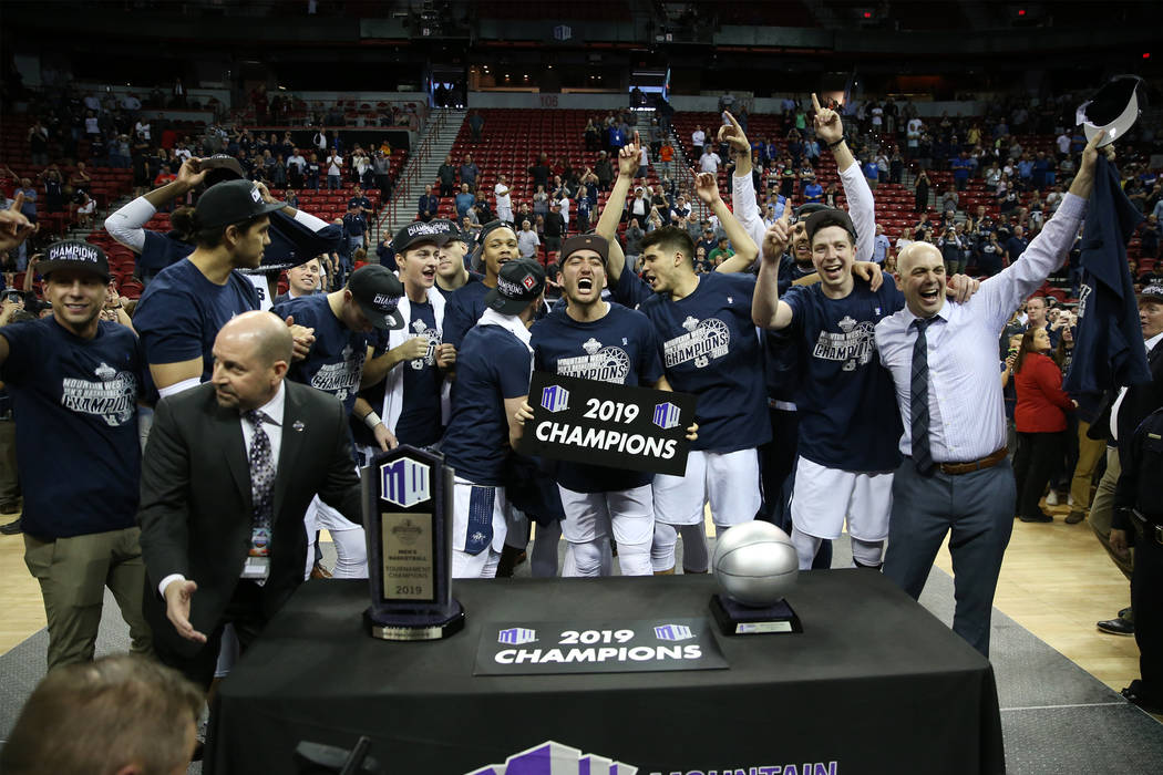 Utah State Aggies celebrate their win against San Diego State Aztecs in the Mountain West tournament men's basketball championship game at the Thomas & Mack Center in Las Vegas, Saturday, Marc ...