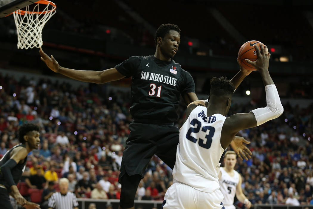 San Diego State Aztecs forward Nathan Mensah (31) defends against Utah State Aggies center Neemias Queta (23) in the second half of the Mountain West tournament men's basketball championship game ...