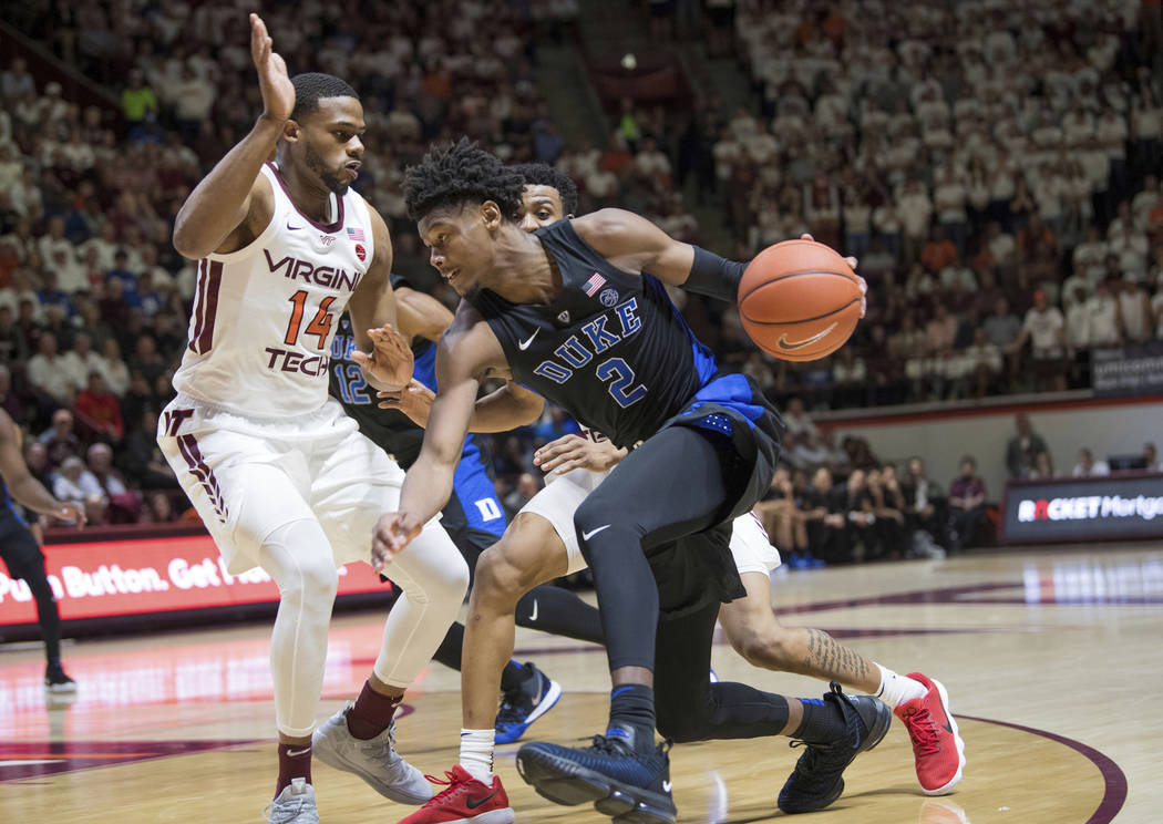 Duke foreword Cam Reddish (2) drives around Virginia Tech defender PJ Horne (14) during the first half of an NCAA college basketball game in Blacksburg, Va., Tuesday, Feb. 26, 2019. (AP Photo/Lee ...