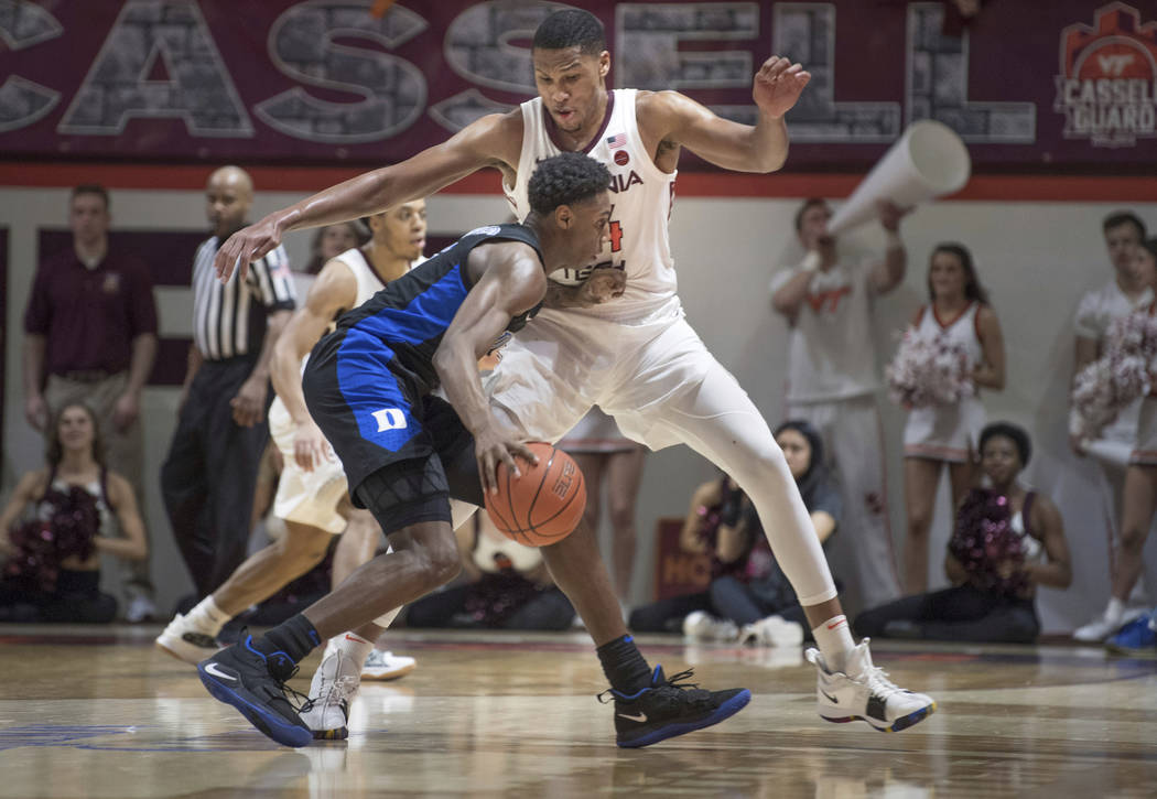 Virginia Tech's Kerry Blackshear Jr. defends against Duke forward RJ Barrett during the second half of an NCAA college basketball game in Blacksburg, Va., Tuesday, Feb. 26, 2019. (AP Photo/Lee Lut ...