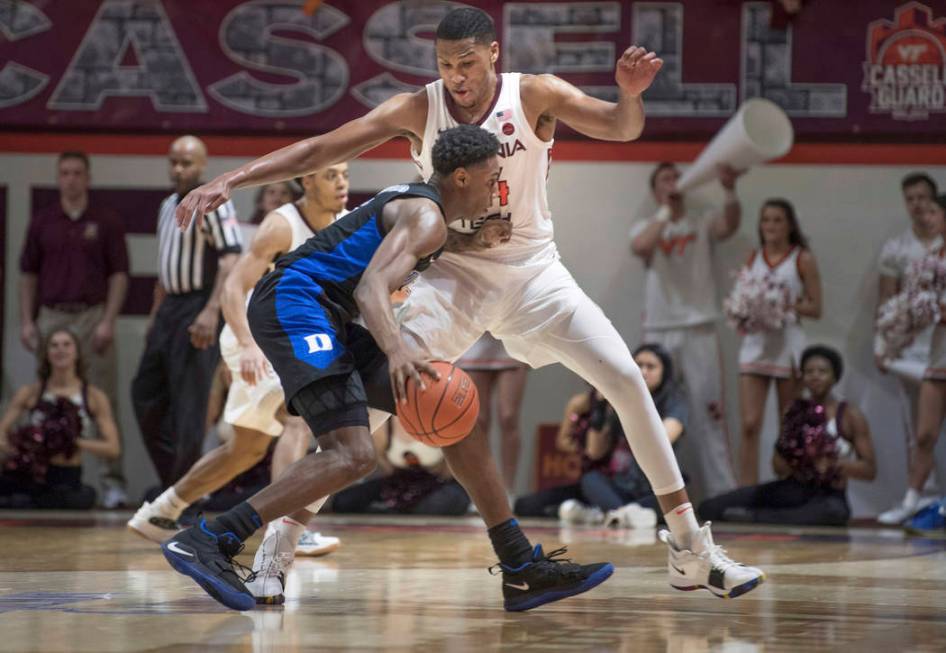 Virginia Tech's Kerry Blackshear Jr. defends against Duke forward RJ Barrett during the second half of an NCAA college basketball game in Blacksburg, Va., Tuesday, Feb. 26, 2019. (AP Photo/Lee Lut ...