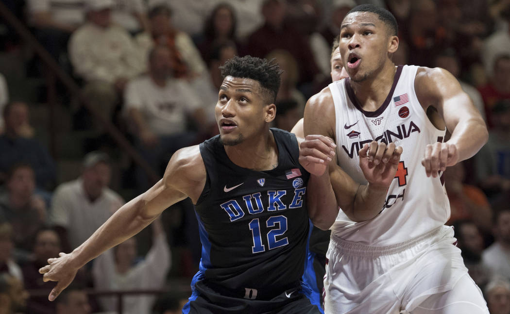 Duke forward Javin DeLaurier (12) and Virginia Tech forward Kerry Blackshear Jr.(24) work for position during a free throw during the second half of an NCAA college basketball game in Blacksburg, ...