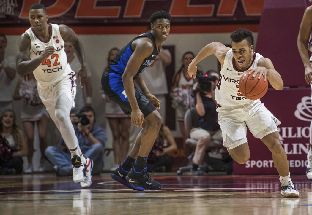 Virginia Tech guard Wabissa Bede (3) starts a fast break near Duke forward RG Barrett during the second half of an NCAA college basketball game in Blacksburg, Va., Tuesday, Feb. 26, 2019. (AP Phot ...