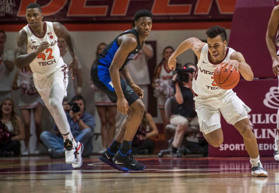 Virginia Tech guard Wabissa Bede (3) starts a fast break near Duke forward RG Barrett during the second half of an NCAA college basketball game in Blacksburg, Va., Tuesday, Feb. 26, 2019. (AP Phot ...