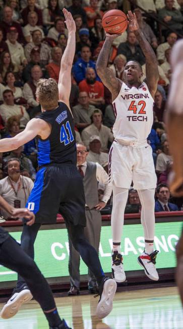 Virginia Tech forward Kerry Backshear Jr (42) shoots a 3-pointer over Duke's Jack White (41) during the first half of an NCAA college basketball game in Blacksburg, Va., Tuesday, Feb. 26, 2019. (A ...