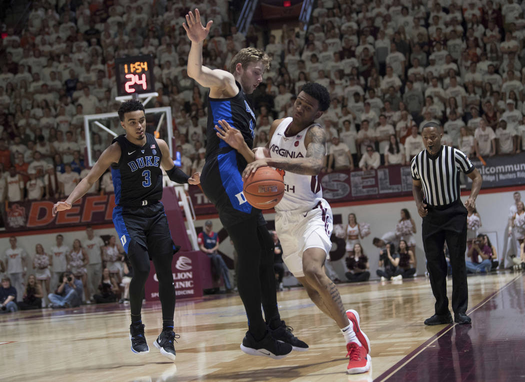 Virginia Tech guard Nickel Alexander-Walker, right, is fouled by Duke defender Jack White during the second half of an NCAA college basketball game in Blacksburg, Va., Tuesday, Feb. 26, 2019. (AP ...