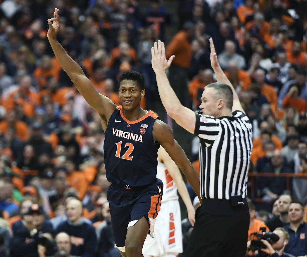 Virginia guard De'Andre Hunter celebrates a three-point basket during the second half of an NCAA college basketball game against Syracuse in Syracuse, N.Y., Monday, March 4, 2019. (AP Photo/Adrian ...