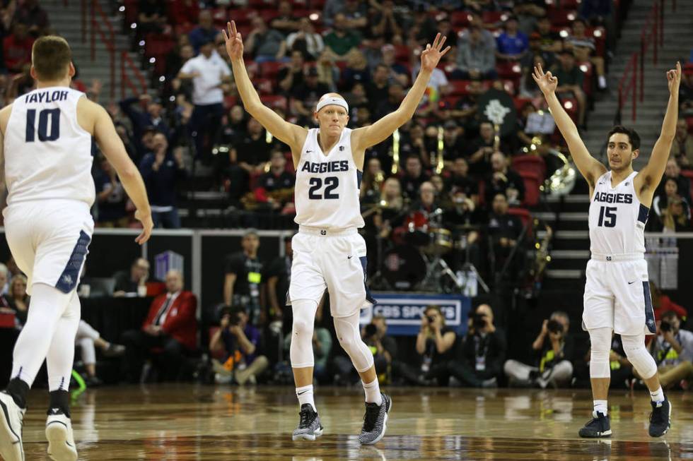 Utah State Aggies guard Brock Miller (22) with guard Abel Porter (15), reacts after making a three-point-shot against the San Diego State Aztecs in the second half of the Mountain West tournament ...