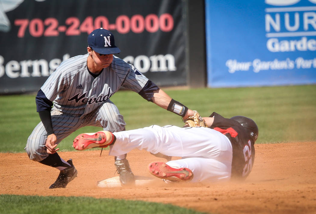 UNR infielder Tyler Bosetti (1) tags UNLV infielder Dillon Johnson (25) as he slides into second base in the fifth inning during an NCAA baseball game at Earl E. Wilson Stadium in Las Vegas, Sunda ...