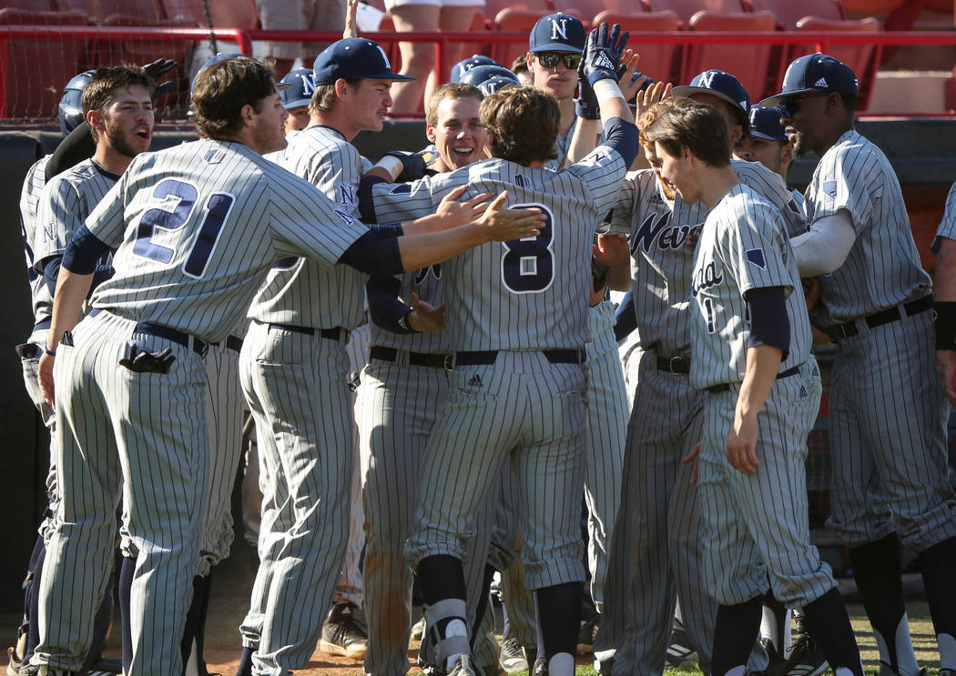 UNR infielder Joshua Zamora (8) celebrates with his teammates after hitting the a game-winning home run in the tenth inning during an NCAA baseball game at Earl E. Wilson Stadium in Las Vegas, Sun ...