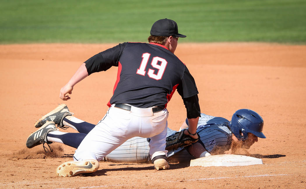 UNR infielder Joshua Zamora (8) slides safely into first base while under pressure from UNLV first baseman Jack-Thomas Wold (19) in the ninth inning during an NCAA baseball game at Earl E. Wilson ...
