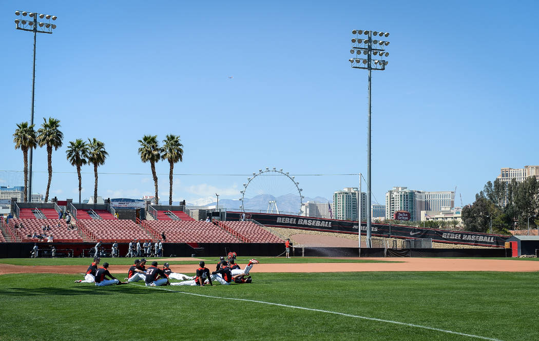 UNLV sits on the field while warming up before a game against UNR during an NCAA baseball game at Earl E. Wilson Stadium in Las Vegas, Sunday, March 24, 2019. (Caroline Brehman/Las Vegas Review-Jo ...
