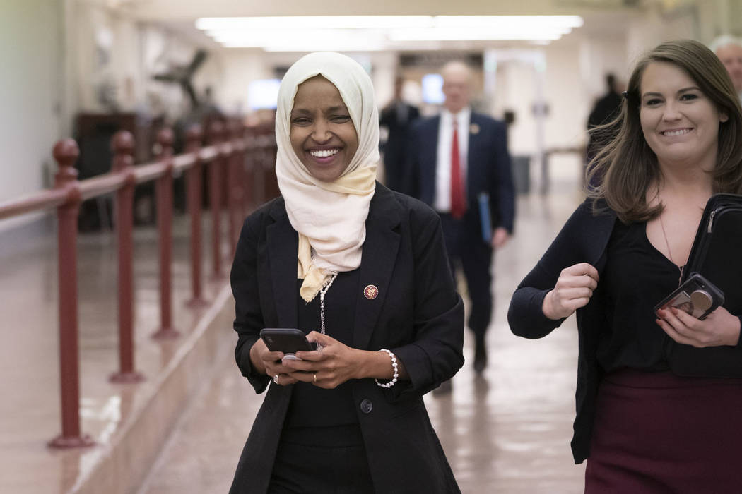 Rep. Ilhan Omar, D-Minn., walks to the chamber Thursday, March 7, 2019, on Capitol Hill in Washington. (AP Photo/J. Scott Applewhite)