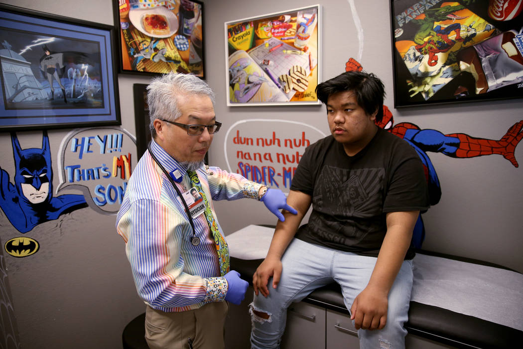 Pulmonologist Dr. Craig Nakamura, director of the Cystic Fibrosis Center of Southern Nevada, examines Rhuniel Getalado, 15, in his Las Vegas office Thursday, March 7, 2019. (K.M. Cannon/Las Vegas ...