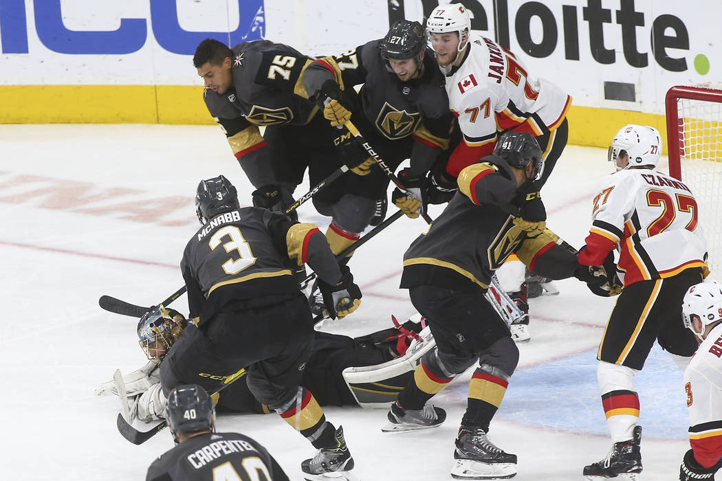 Golden Knights goaltender Marc-Andre Fleury dives to stop the puck during the third period of an NHL hockey game against the Calgary Flames at T-Mobile Arena in Las Vegas on Wednesday, March 6, 20 ...