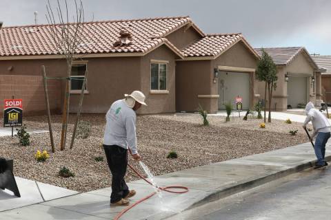 Construction workers wash the sidewalk at the new construction site of LGI Homes at the Intersection of E. Lake Mead Boulevard and Dolly Lane photographed on Friday, March. 8, 2019, in Las Vegas. ...