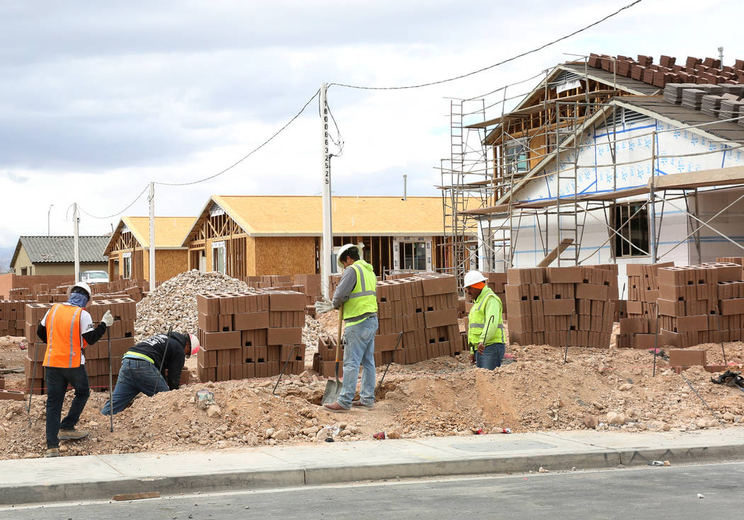 Construction workers build wall during the new construction of LGI Homes at the Intersection of E. Lake Mead Boulevard and Dolly Lane photographed on Friday, March. 8, 2019, in Las Vegas. Bizuayeh ...