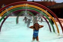 A girl runs under the cold water at Doolittle Community Center Pool. (File)