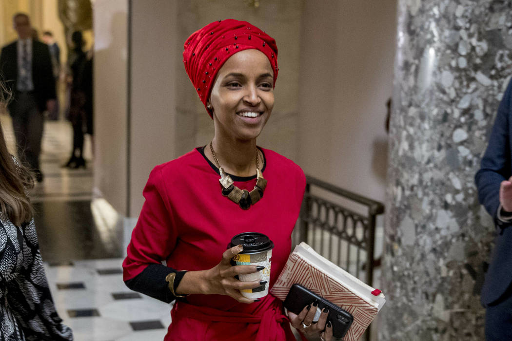 In this Jan. 16, 2019 file photo, Rep. Ilhan Omar, D-Minn., center, walks through the halls of the Capitol Building in Washington. (AP Photo/Andrew Harnik)