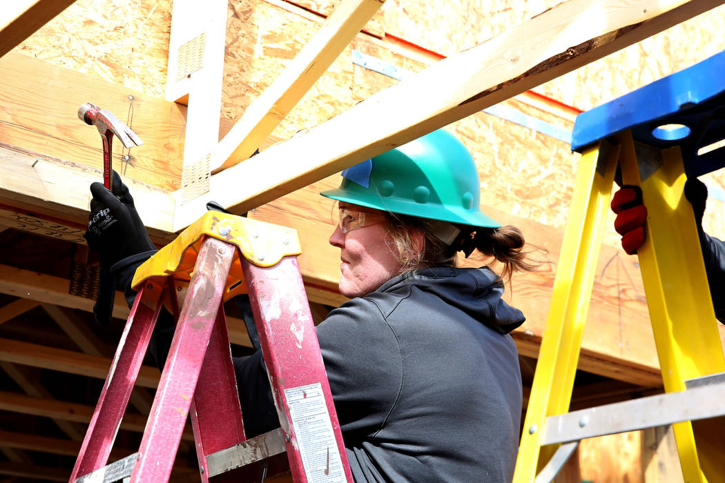 Las Vegas Aces center Carolyn Swords hits the nail as she volunteers to help with the construction of Habitat for Humanity Las Vegasՠ112th home in celebration of International Womenճ Day on Frid ...