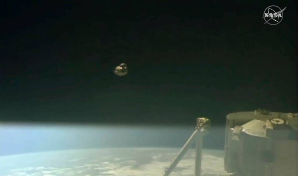 In this image taken from NASA Television, SpaceX's swanky new crew capsule, center, takes off after undocking from the International Space Station, right, Friday, March 8, 2019. The capsule undoc ...