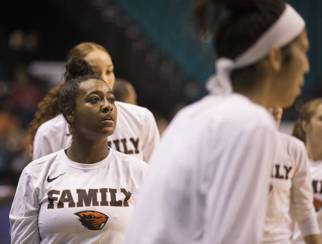 Oregon State junior guard Madison Washington, left, a Las Vegas native and Bishop Gorman graduate, warms up before the start of the Beavers Pac 12 Tournament game with the Washington Huskies on Fr ...