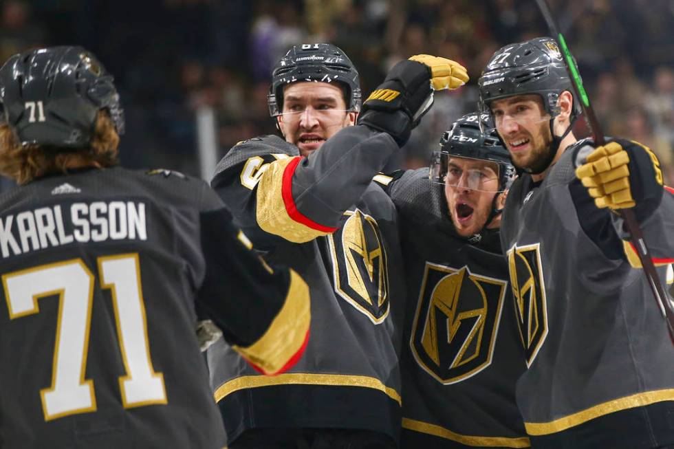 Golden Knights right wing Mark Stone, second from left, celebrates the goal scored by defenseman Shea Theodore, right, with their teammates center William Karlsson (71) and center Jonathan March ...