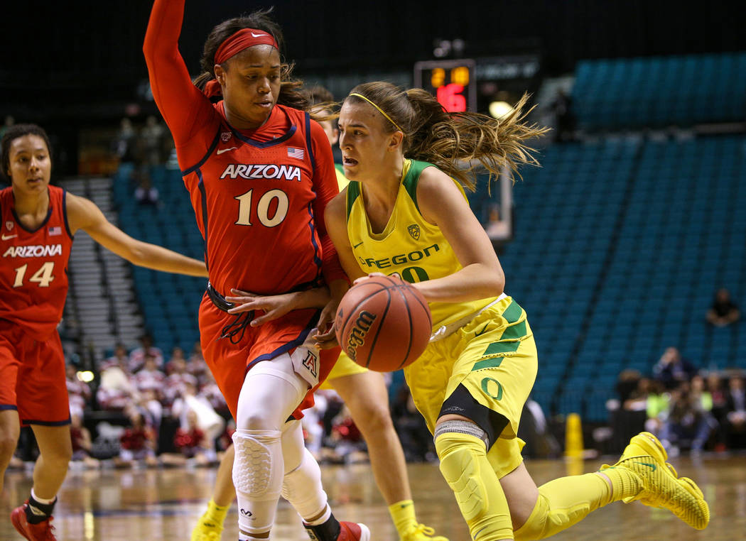 Oregon Ducks guard Sabrina Ionescu (20) drives past Arizona Wildcats forward Tee Tee Starks (10) with the ball during the second half of an NCAA college basketball game at the Pac-12 women's tourn ...