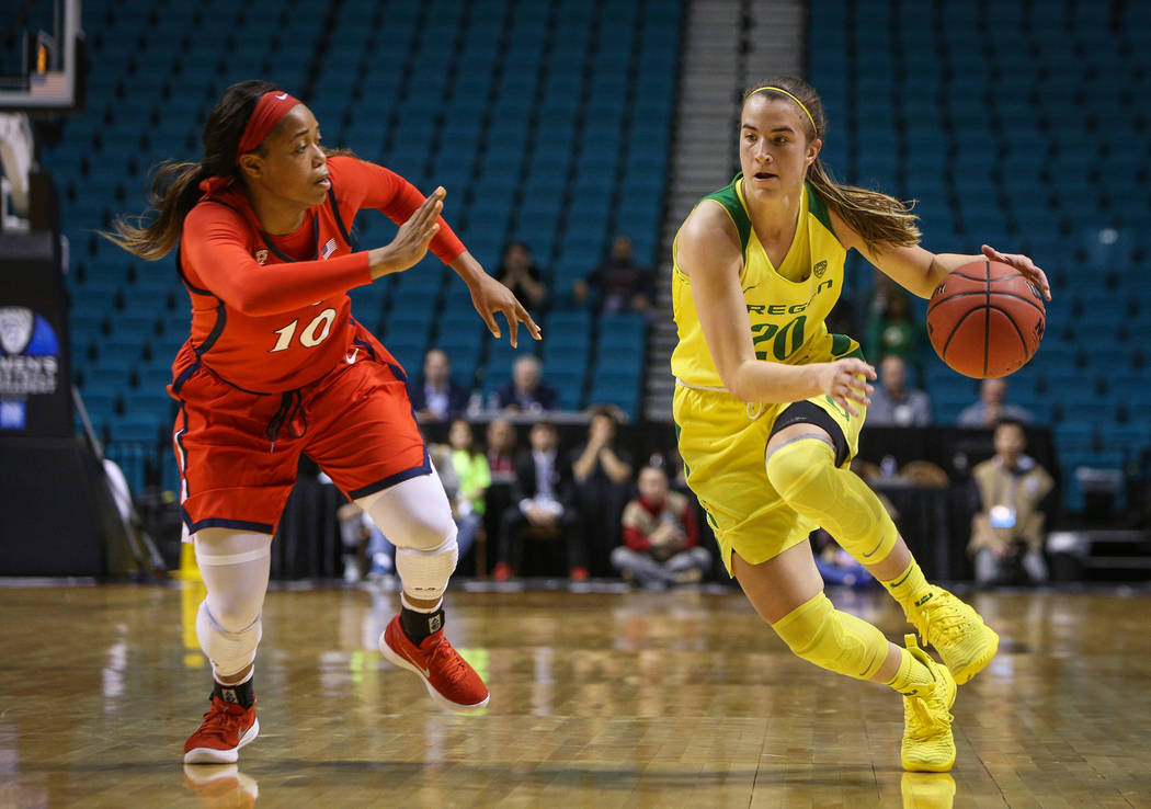 Oregon Ducks guard Sabrina Ionescu (20) dribbles with the ball down the court while being guarded by Arizona Wildcats forward Tee Tee Starks (10) during the second half of an NCAA college basketba ...
