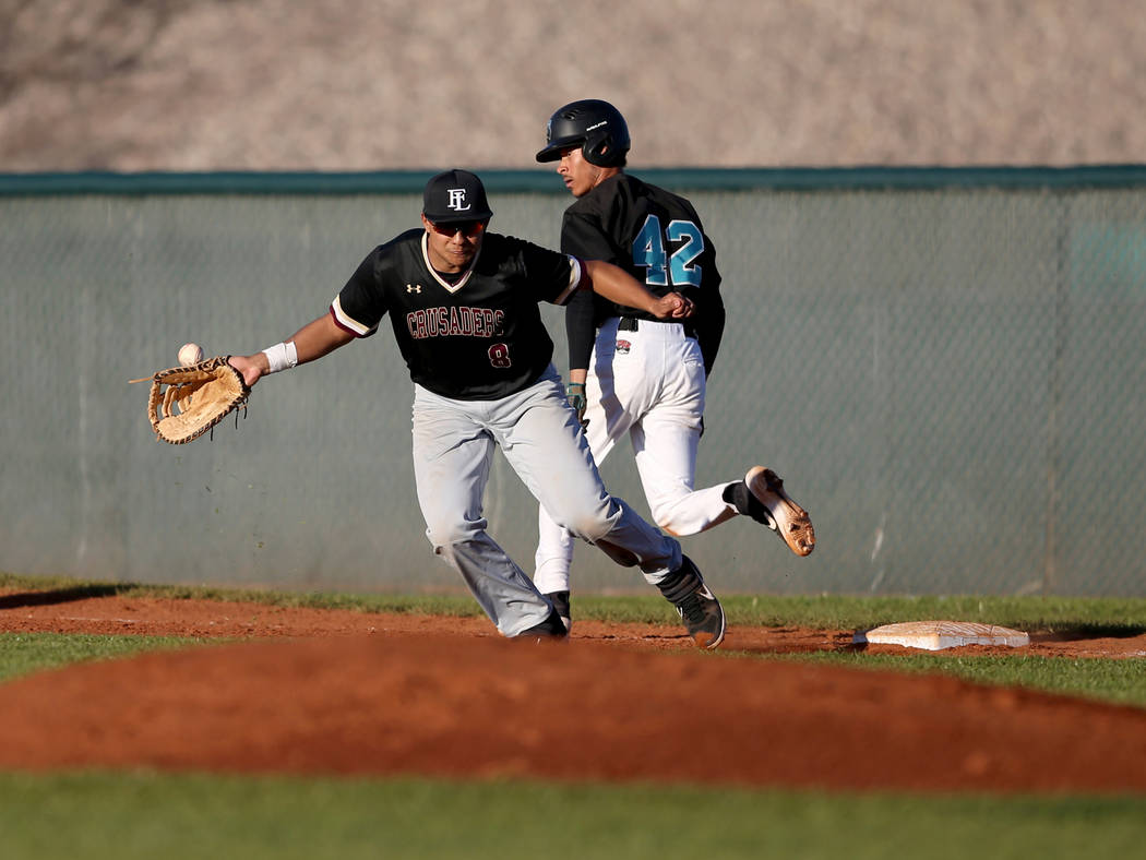 Silverado baserunner Caleb Hubbard (42) crosses first base as Faith Lutheran first baseman Jacob Ortega (8) fields a short hop during a baseball game at Silverado High School in Las Vegas Friday, ...