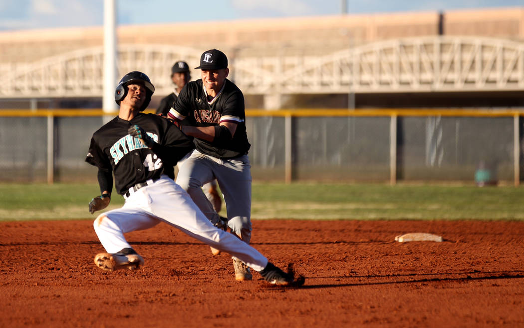 Faith Lutheran shortstop Parker Sylvester (5) tags out Silverado baserunner Caleb Hubbard (42) in a rundown during a baseball game at Silverado High School in Las Vegas Friday, March 8, 2019. (K.M ...