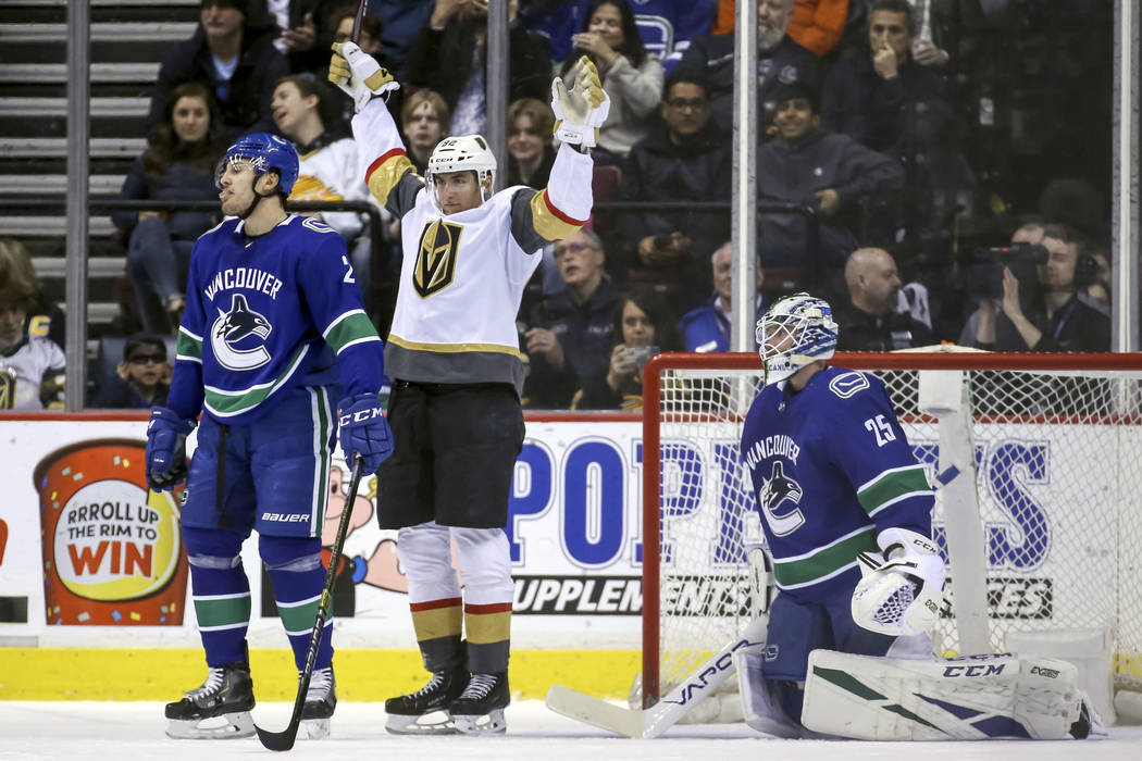 Vegas Golden Knights' Tomas Nosek (92) celebrates his goal near Vancouver Canucks goaltender Jacob Markstrom (25) during the first period of an NHL hockey game in Vancouver, British Columbia, Satu ...