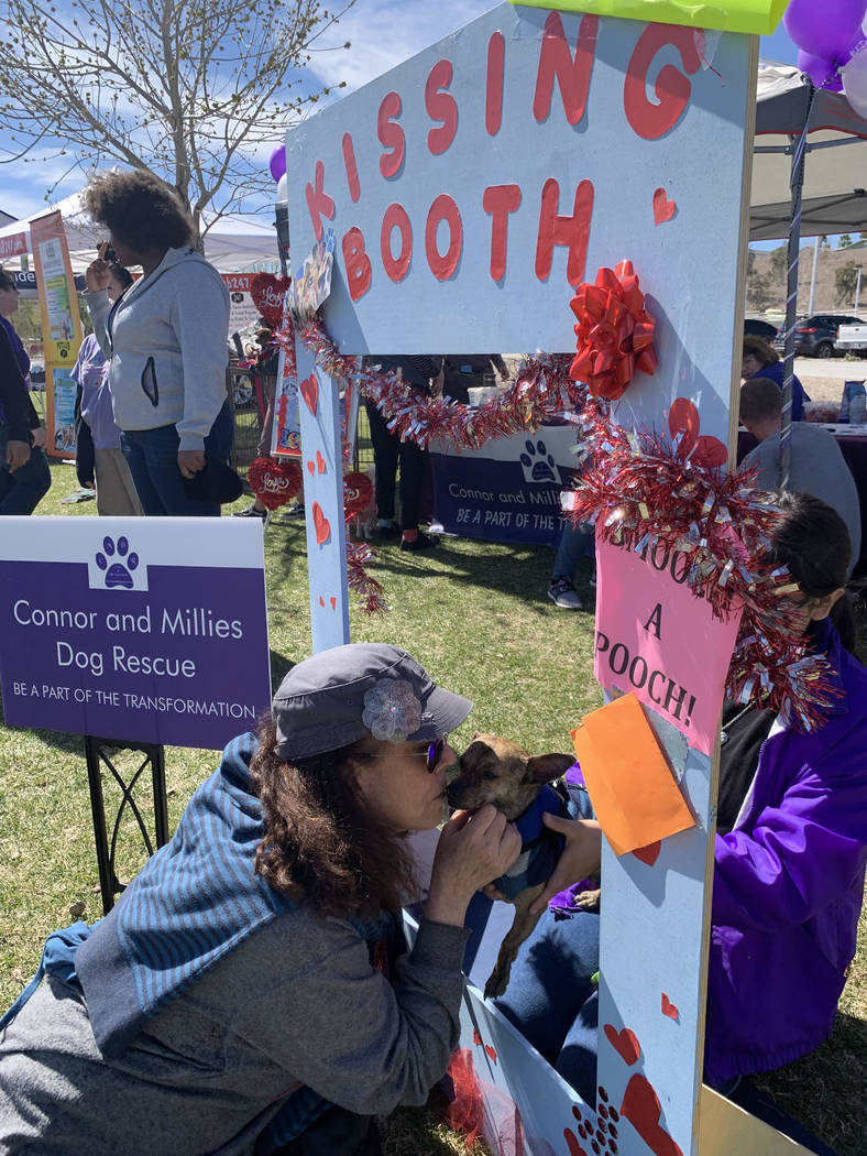 Faith Goffstein, a Las Vegas resident and self-proclaimed dog lover, poses with Romeo, a 2-year-old chihuahua mix up for adoption at Connor and Millieճ Dog Rescue tent at the 16th annual Bar ...