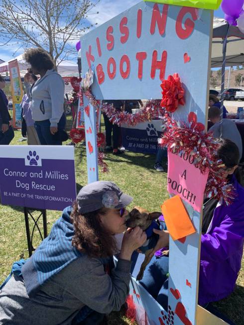 Faith Goffstein, a Las Vegas resident and self-proclaimed dog lover, poses with Romeo, a 2-year-old chihuahua mix up for adoption at Connor and Millieճ Dog Rescue tent at the 16th annual Bar ...