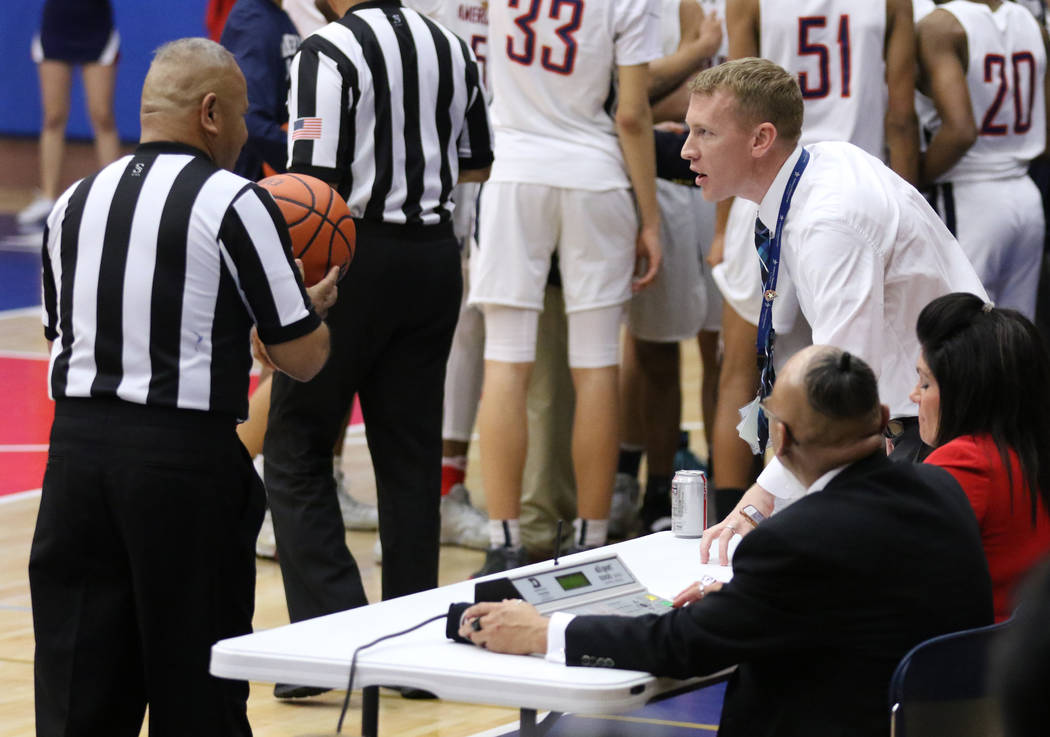 American Preparatory Academy's secondary director, Nik Hulet, right, speaks to a referee during a varsity basketball game played against SLAM Academy on his school's campus in Las Vegas, Thursday, ...