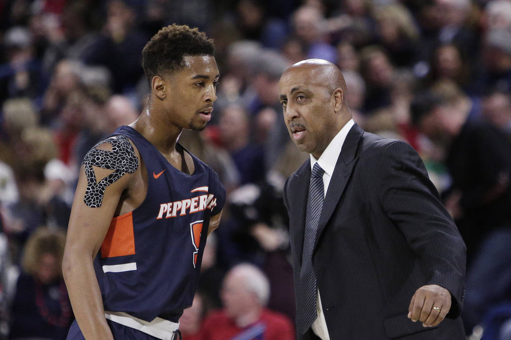 Pepperdine head coach Lorenzo Romar, right, speaks with guard Jade' Smith during the second half of an NCAA college basketball game against Gonzaga in Spokane, Wash., Thursday, Feb. 21, 2019. (AP ...