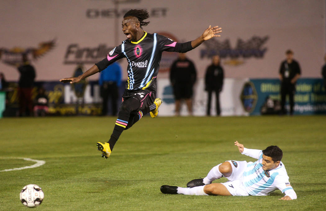 Las Vegas Lights FC midfielder Alex Nyarko Harlley (14) jumps over Austin Bold FC forward Julian Gaines (7) during the first half of a United Soccer League match at Cashman Field in Las Vegas, Sat ...