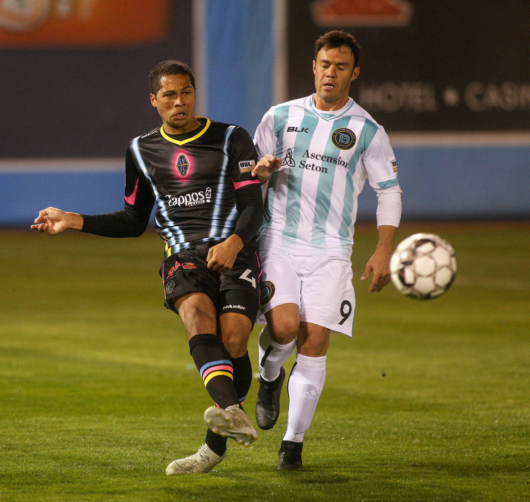 Las Vegas Lights FC defender Gabe Robinson (4) passes to a teammate while being guarded by Austin Bold FC forward Kleber Giacomazzi (9) during the first half of a United Soccer League match at Cas ...