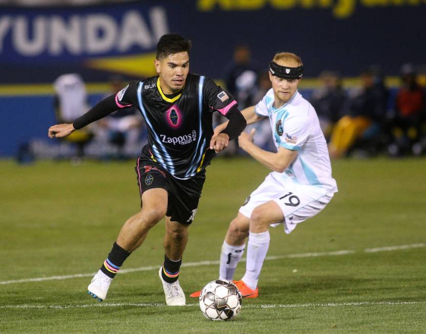 Las Vegas Lights FC midfielder Cristhian Hernandez (10) moves with the ball past Austin Bold FC forward Kris Tyrpak (19) during the first half of a United Soccer League match at Cashman Field in L ...