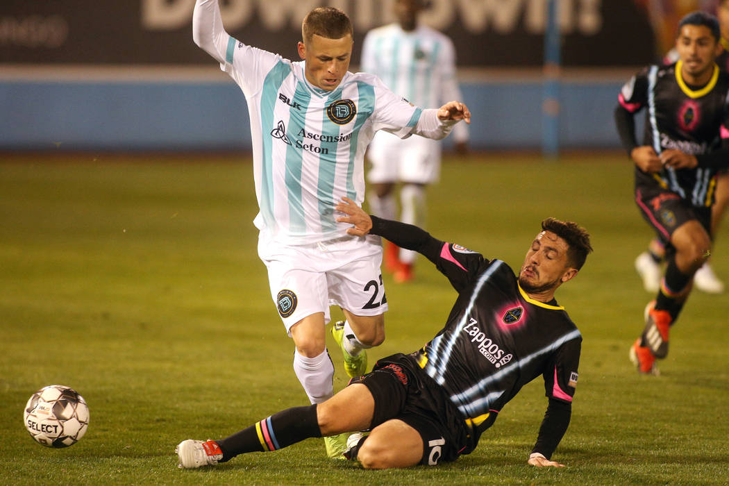 Las Vegas Lights FC midfileder Lucas Scaglia (16) slides into Austin Bold FC forward Clayton Adams (22) for the ball during the second half of a United Soccer League match at Cashman Field in Las ...