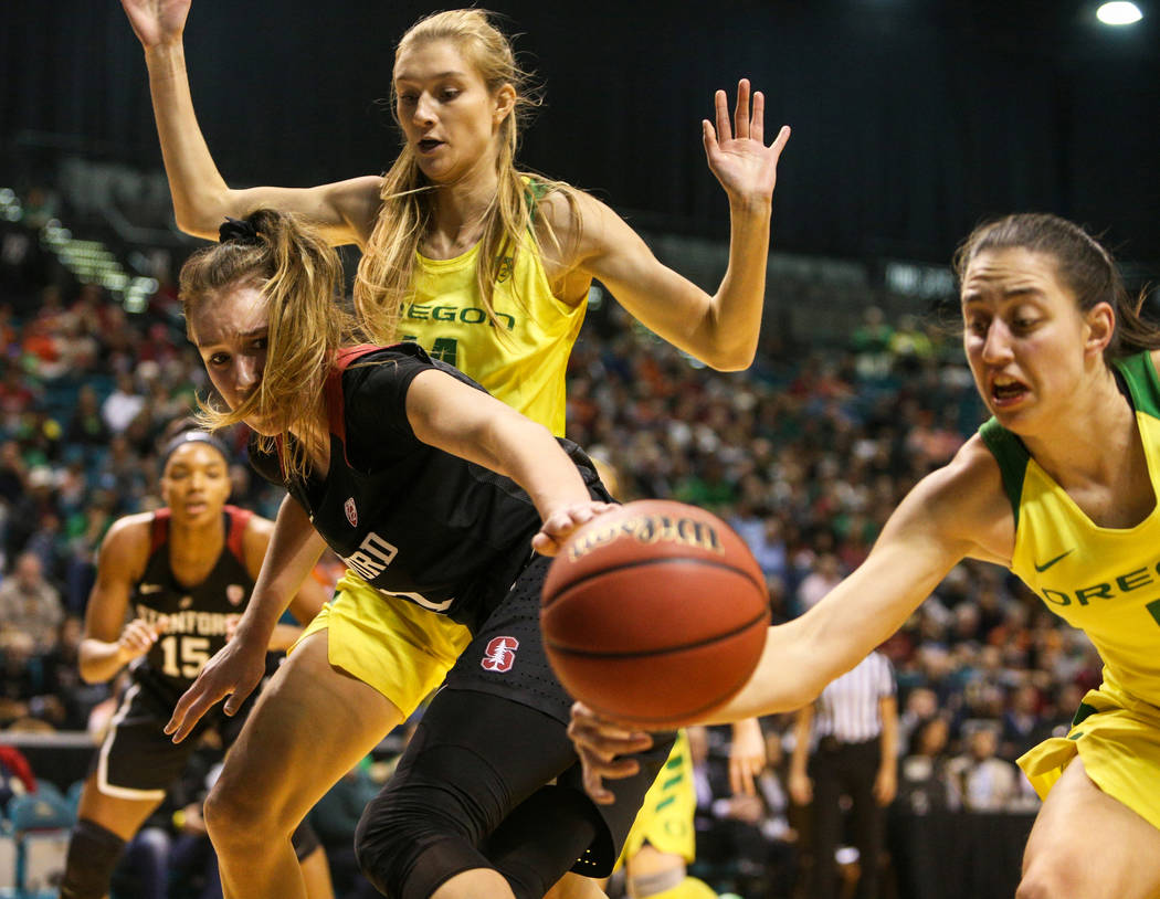 Stanford Cardinal forward Alanna Smith (11) gets the ball knocked out of her hand by Oregon Ducks guard Maite Cazorla (5) as Oregon Ducks guard Maite Cazorla (5) stands behind during the first hal ...