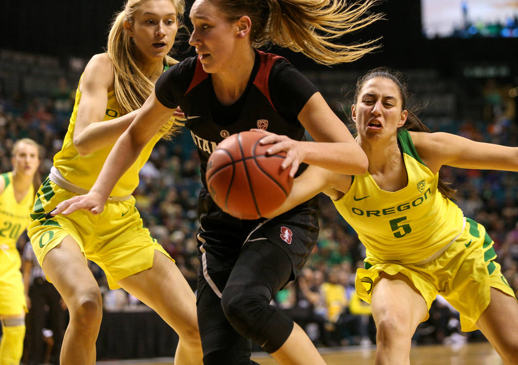 Stanford Cardinal forward Alanna Smith (11) gets the ball knocked out of her hand by Oregon Ducks guard Maite Cazorla (5) as Oregon Ducks guard Maite Cazorla (5) looks on during the first half of ...