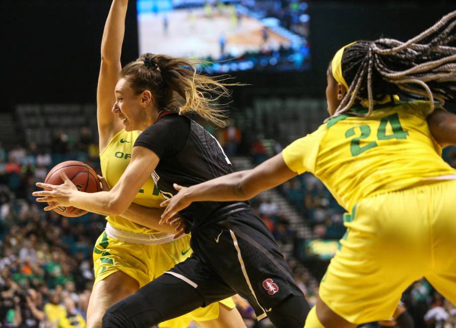 Stanford Cardinal forward Alanna Smith (11) drives past Oregon Ducks forward Erin Boley (21) as Oregon Ducks forward Ruthy Hebard (24) reaches for the ball during the first half of an NCAA college ...