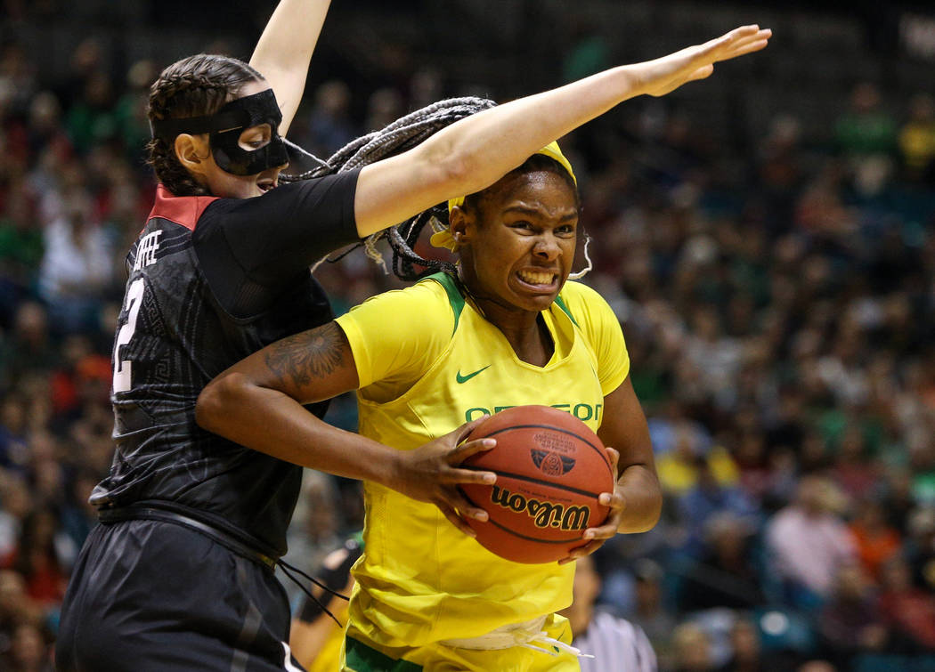 Oregon Ducks forward Ruthy Hebard (24) drives past Stanford Cardinal center Shannon Coffee (2) during the second half of an NCAA college basketball game at the Pac-12 women's tournament at the MGM ...