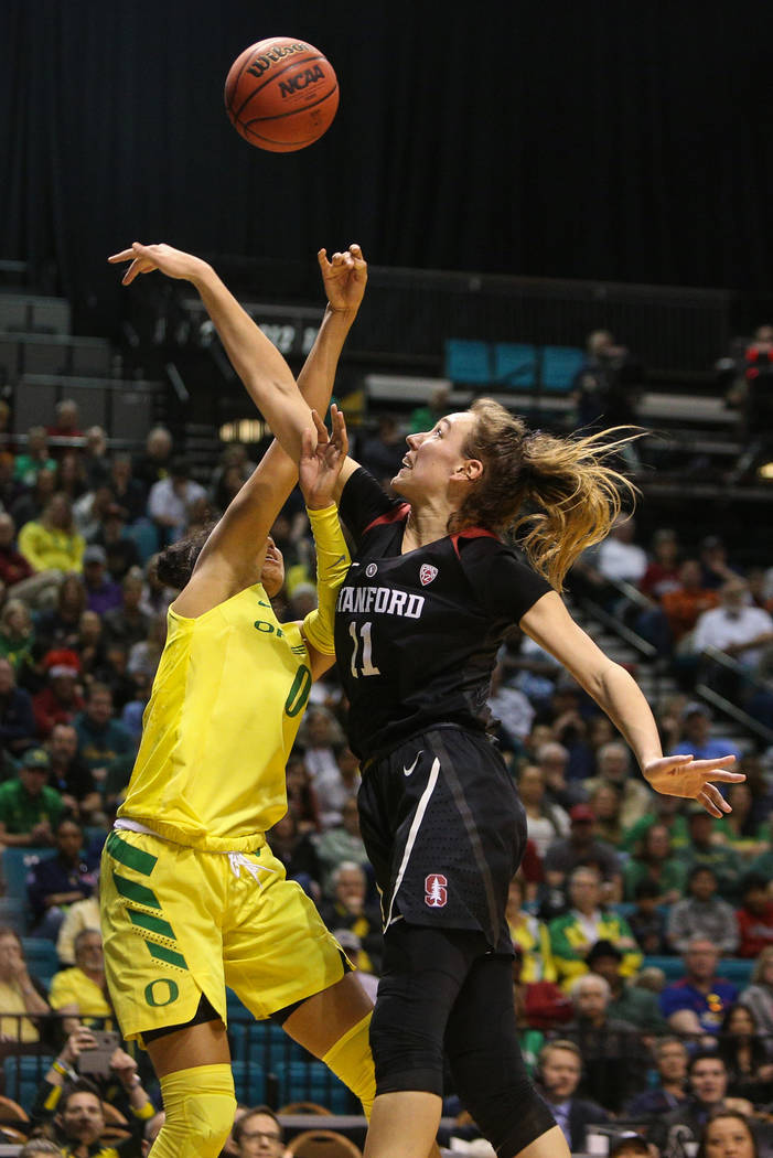 Stanford Cardinal forward Alanna Smith (11) knocks the ball out of the hands of Oregon Ducks forward Satou Sabally (0) during the second half of an NCAA college basketball game at the Pac-12 women ...