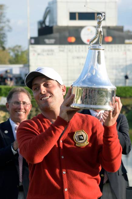 Francesco Molinari, of Italy, lifts the championship trophy after winning the Arnold Palmer Invitational golf tournament Sunday, March 10, 2019, in Orlando, Fla. (AP Photo/Phelan M. Ebenhack)