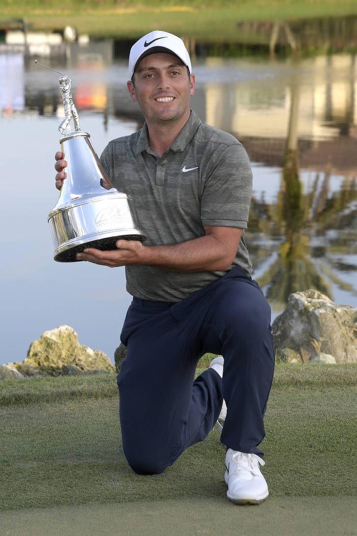 Francesco Molinari, of Italy, poses with the championship trophy after winning the Arnold Palmer Invitational golf tournament Sunday, March 10, 2019, in Orlando, Fla. (AP Photo/Phelan M. Ebenhack)