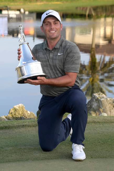 Francesco Molinari, of Italy, poses with the championship trophy after winning the Arnold Palmer Invitational golf tournament Sunday, March 10, 2019, in Orlando, Fla. (AP Photo/Phelan M. Ebenhack)